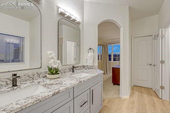 Image 23 of 44: Primary bathroom dual vanity. 5 piece bath with attached walk in closet