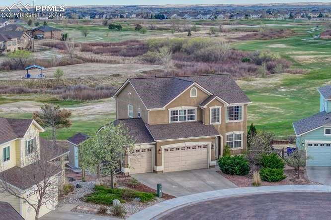 Image 36 of 44: Aerial view of the front of the house and golf course behind