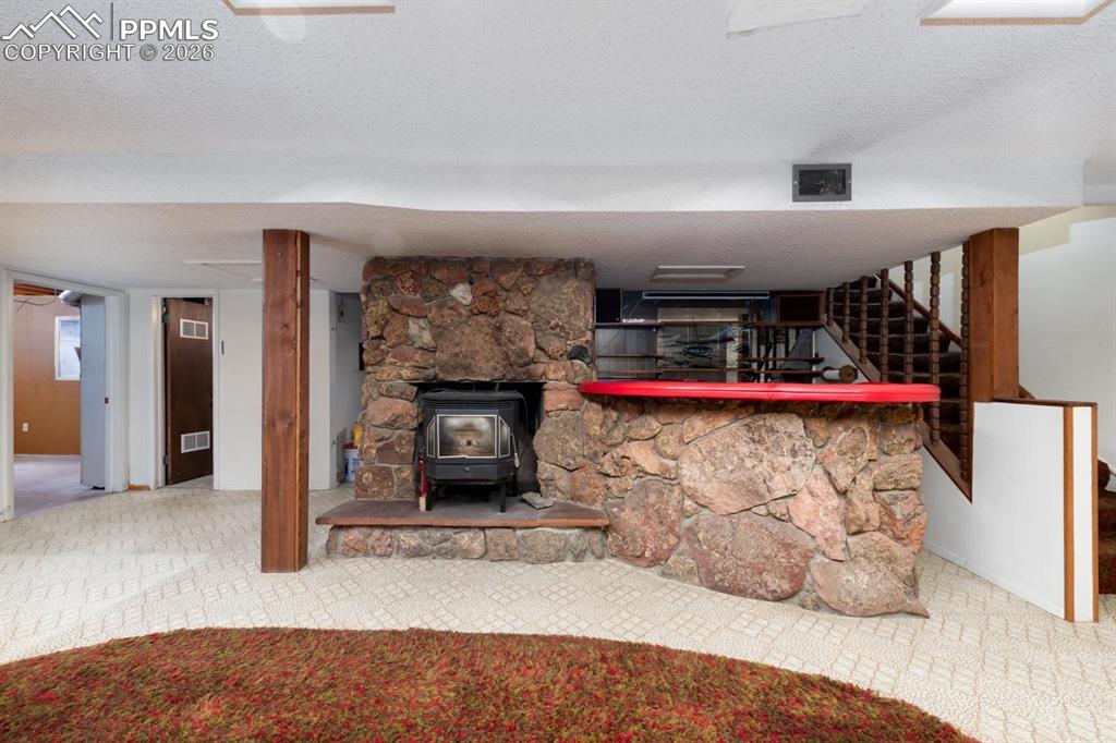 Image 20 of 34: Stove and wet bar in the basement