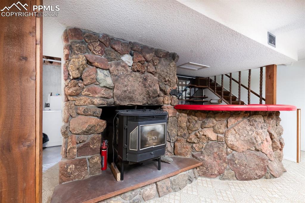 Image 21 of 34: Stove and wet bar in the basement
