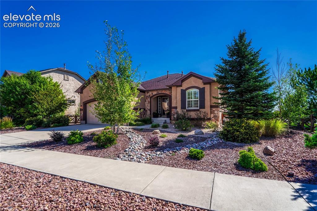Caption: Beautifully landscaped front yard