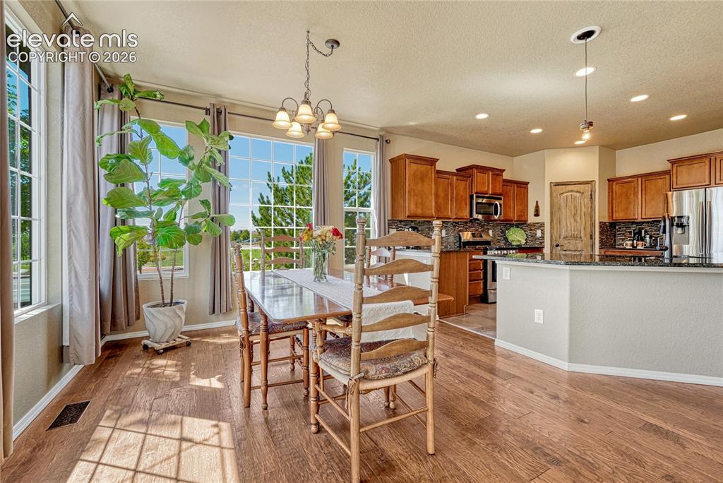 Image 17 of 50: Dining area open to both the kitchen and living room