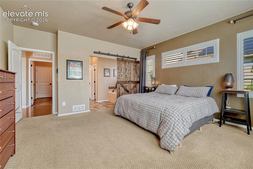 Image 21 of 50: The spacious primary bedroom offers a relaxing retreat