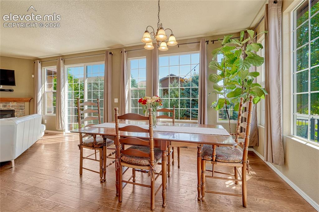 Image 3 of 50: Open dining area surrounded with windows