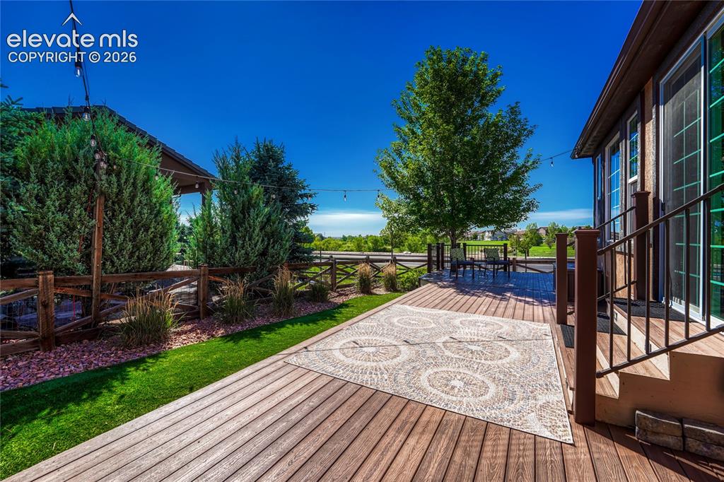 Image 39 of 50: Fabulous composite deck overlooking the neighborhood open space right acros