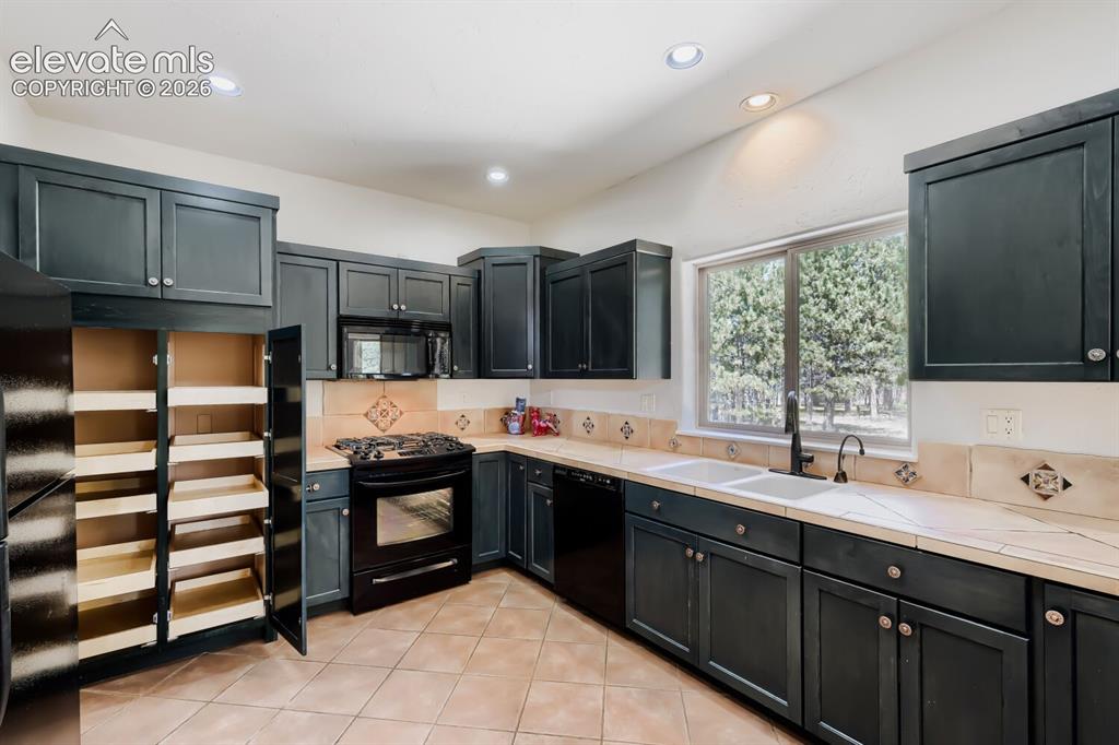 Image 13 of 50: Cabinets are nice dark green
