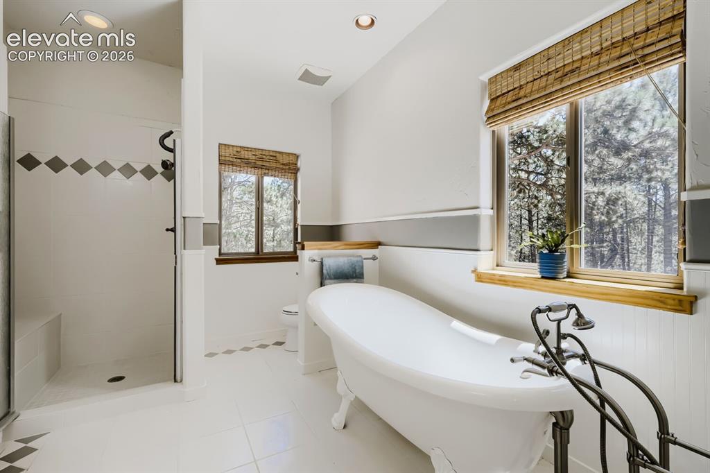 Image 25 of 50: Full bath on main serving guests and secondary bedroom