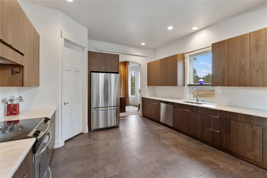 Image 19 of 50: Kitchen with authentic black walnut cabinets and gorgeous quartz counter to