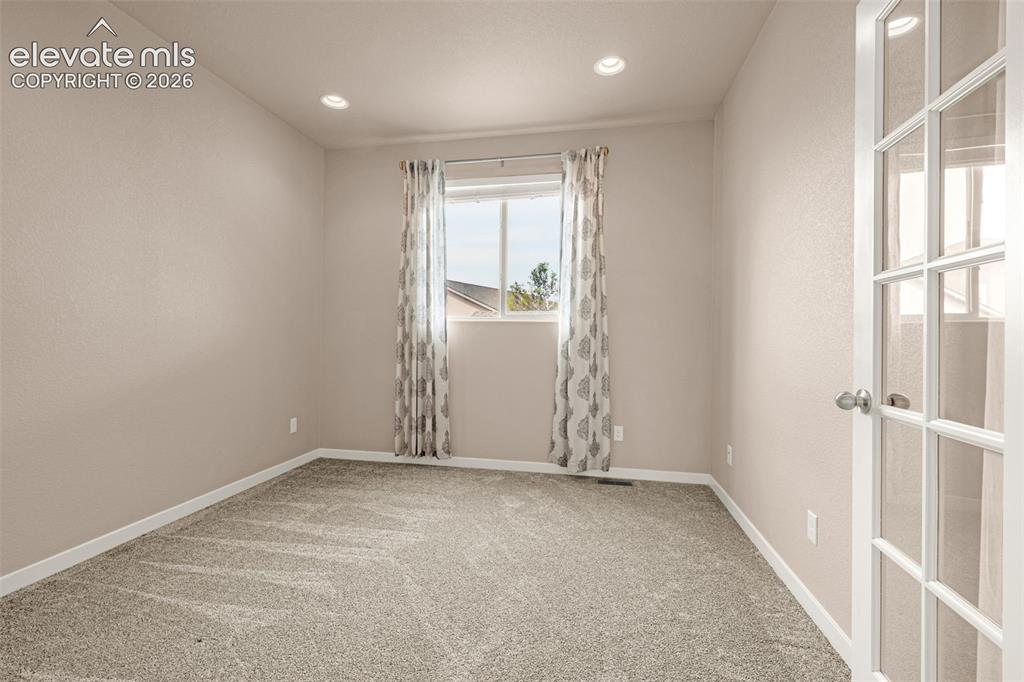 Image 12 of 44: Office near entry and family room 