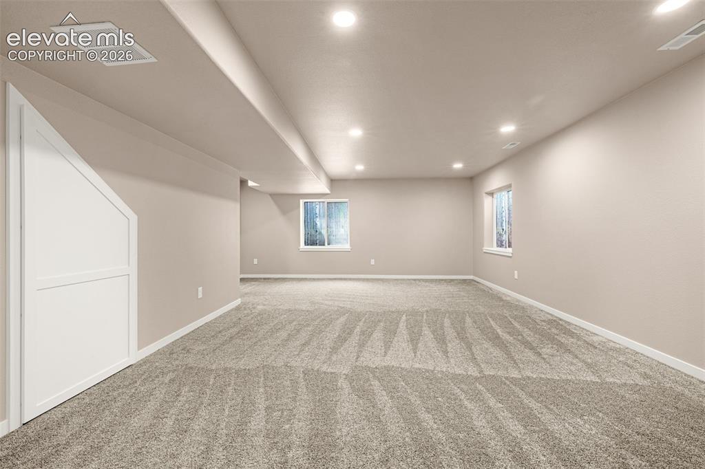 Image 34 of 44: Family Room in basement view from Bathroom