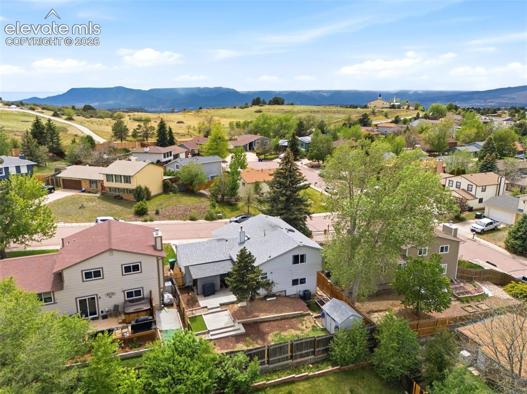 Image 2 of 45: Expansive residential area featuring distant mountain scenery under a clear