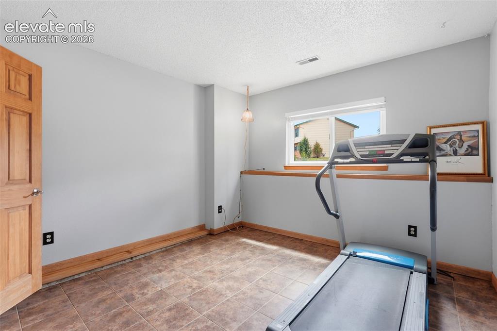 Image 24 of 45: Carpeted room with a horizontal window featuring a wood-finish sill and tri