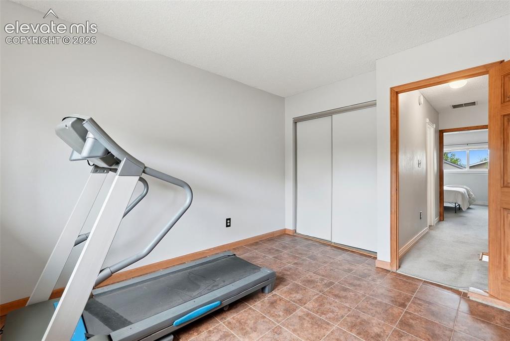 Image 25 of 45: Bedroom featuring light gray wall paint, light gray carpeting, wood baseboa