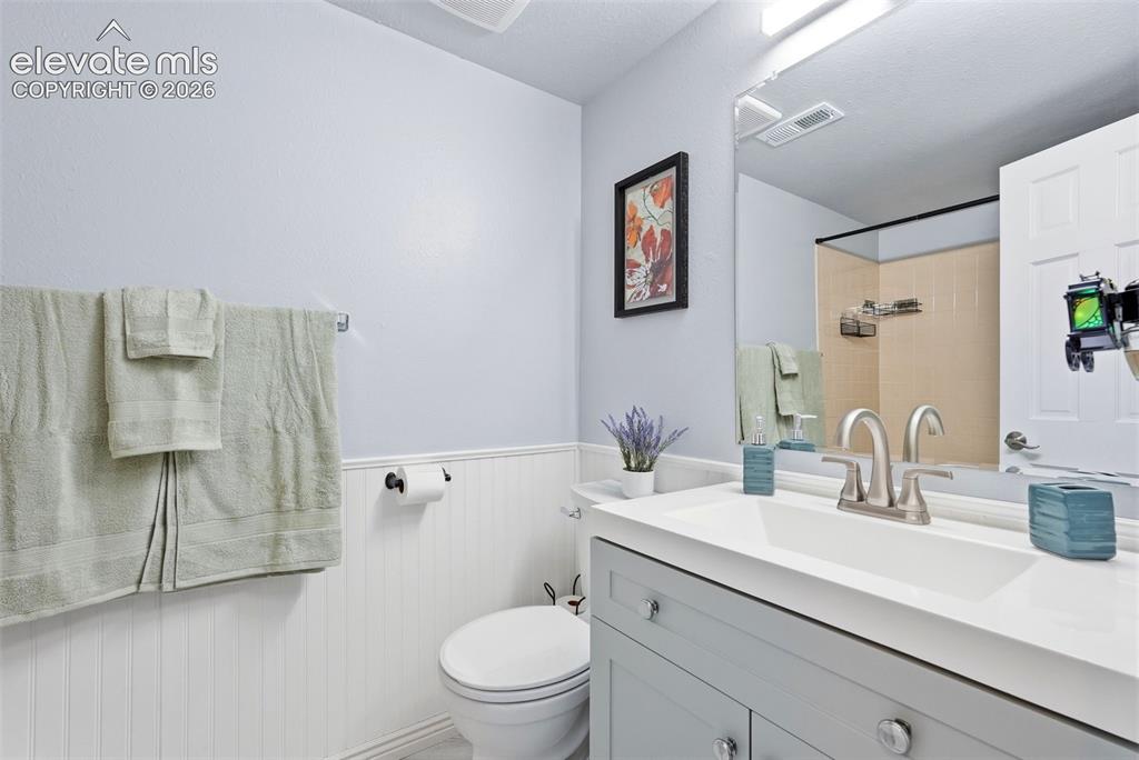 Image 26 of 45: Bathroom vanity featuring a white countertop, undermount sink, and brushed