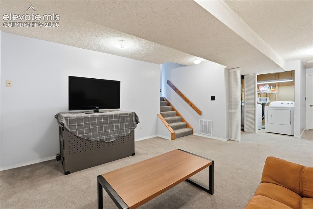Image 29 of 45: Spacious room featuring light gray walls, patterned carpet flooring, ceilin