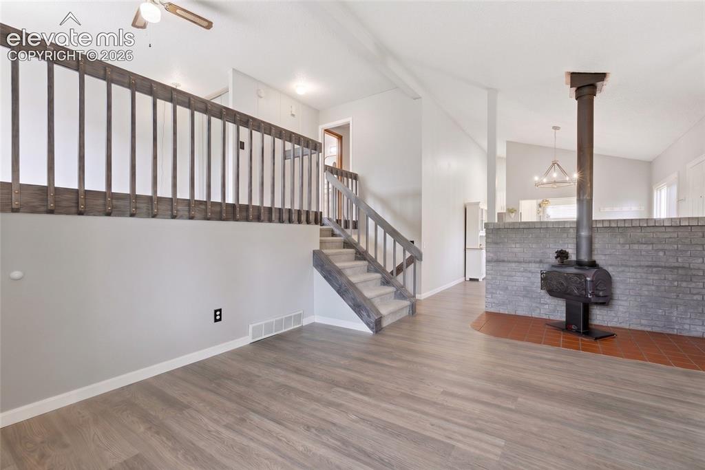 Image 4 of 45: Open-concept living space with wood-finish flooring
