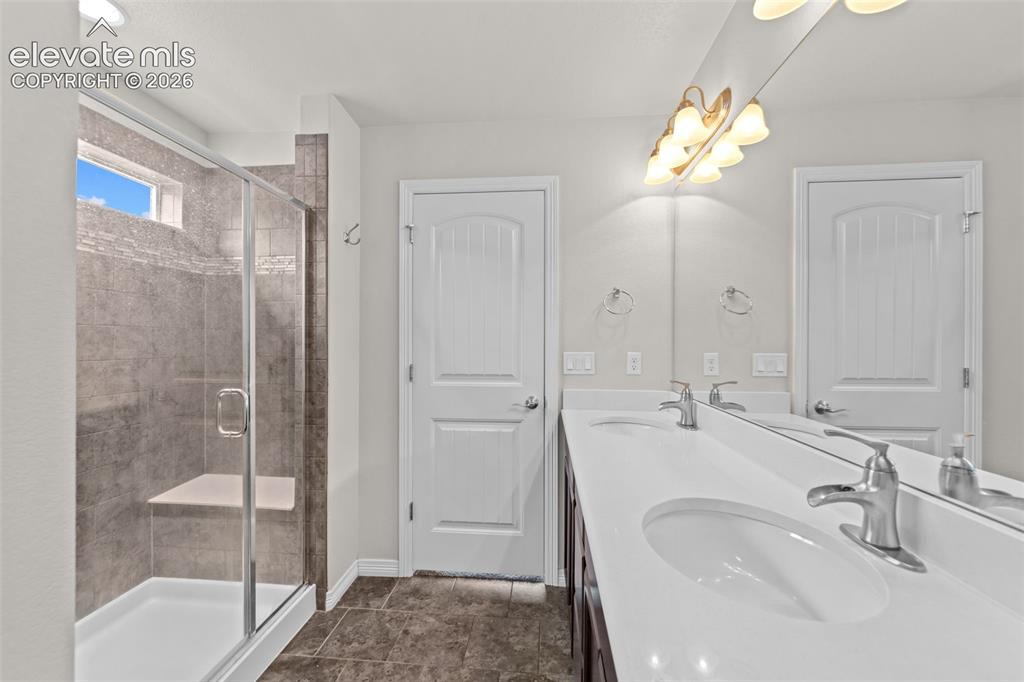 Image 15 of 40: Dual vanity with integrated sinks and chrome fixtures