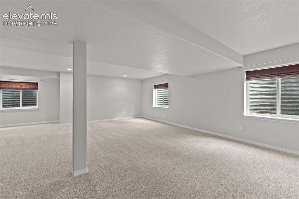 Image 20 of 40: Spacious finished basement with neutral carpet flooring, recessed ceiling l