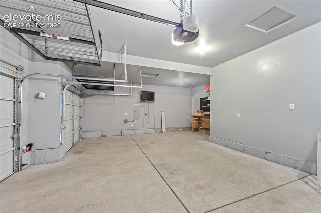 Image 25 of 40: Concrete flooring and overhead storage racks
