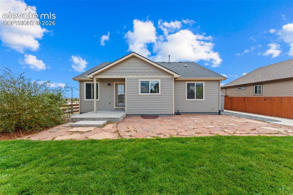 Image 26 of 40: Modern ranch-style home featuring a freshly finished exterior with light-co