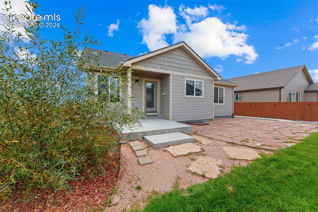 Image 28 of 40: Siding exterior with decorative shake accents, an inviting concrete front p