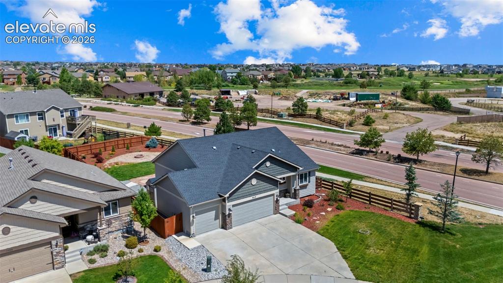 Image 30 of 40: Ranch-style exterior with a two-car garage, concrete driveway, and landscap