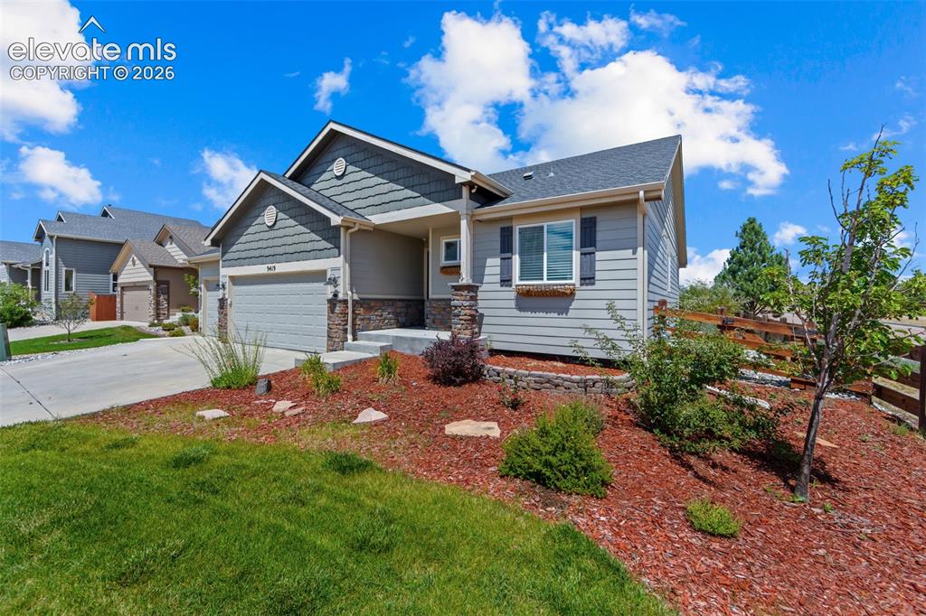 Image 4 of 40: Siding exterior with stone accents, a two-car garage, and a covered porch e