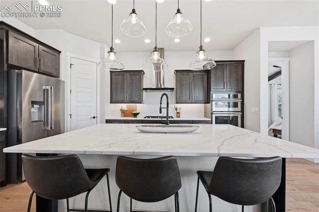 Image 14 of 46: Huge kitchen island with quartz counters