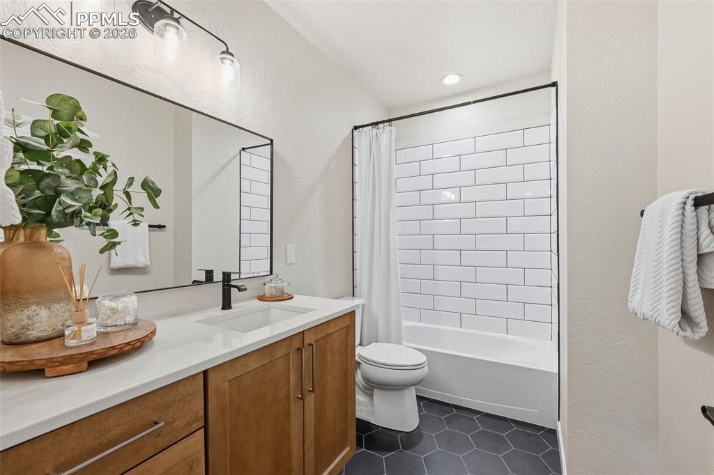 Image 38 of 46: Full bath with upgraded tile, cabinets and countertops