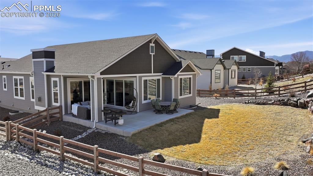 Image 42 of 46: Large back yard with grass and rocks