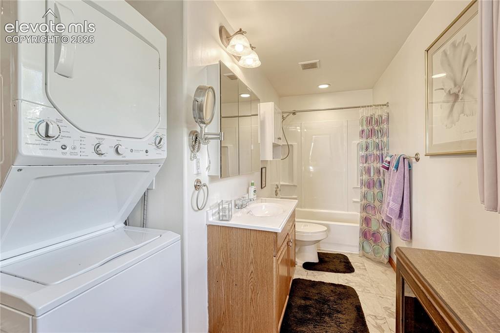 Image 13 of 50: Bathroom with washer and dryer