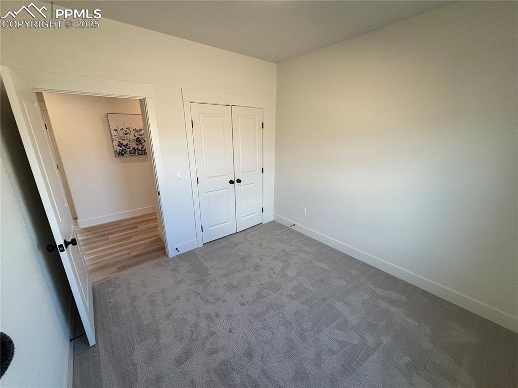 Image 14 of 19: Unfurnished bedroom with carpet floors and a closet
