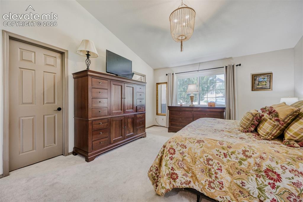 Image 15 of 29: Vaulted ceilings complemented by a decorative chandelier