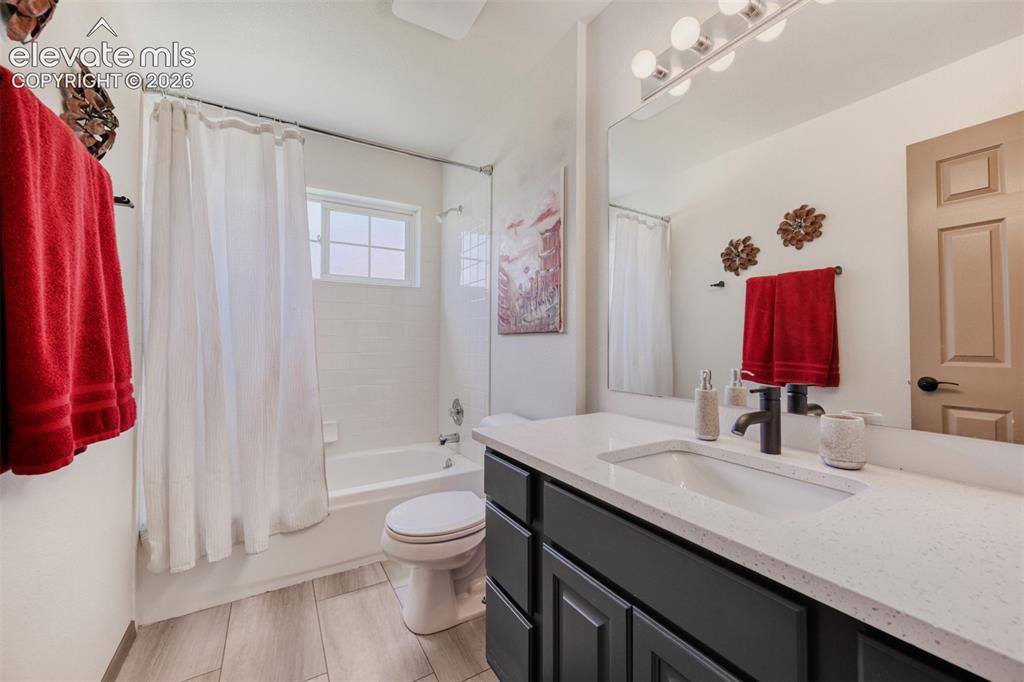 Image 23 of 29: Bathroom featuring a vanity, a light-toned countertop, a rectangular underm
