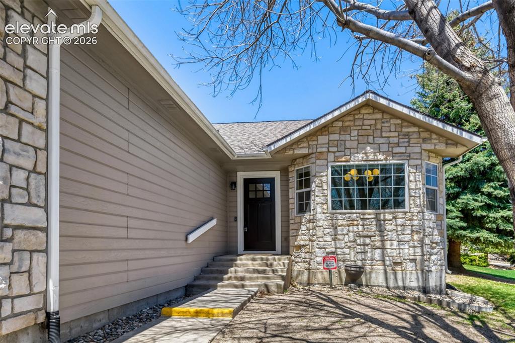 Image 3 of 29: Stone facade and horizontal siding exterior
