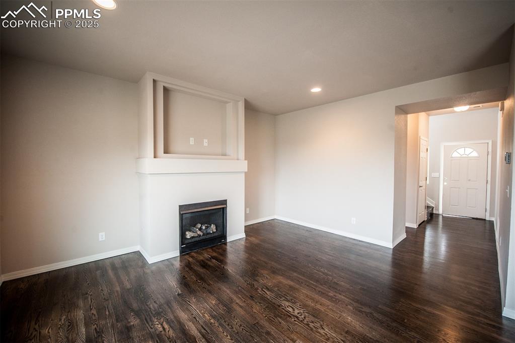 Image 3 of 29: Living room featuring gas fireplace and LVP flooring