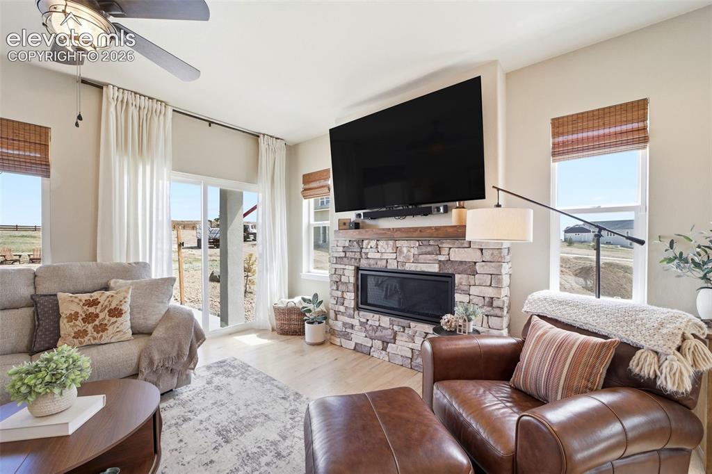 Image 15 of 49: Stone fireplace with mantel for those winter nights coming. 