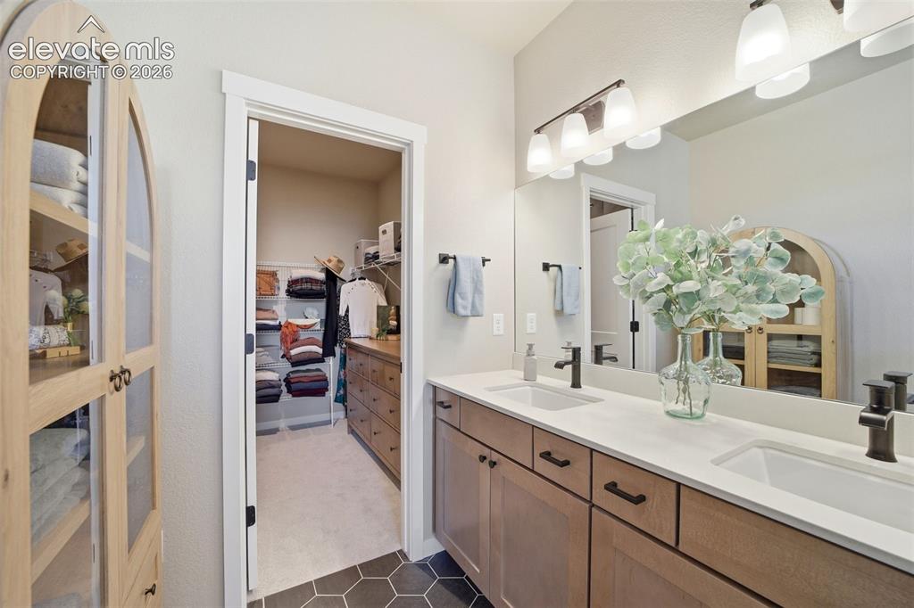 Image 19 of 49: On-suite Primary bathroom with styled, timeless design pieces.