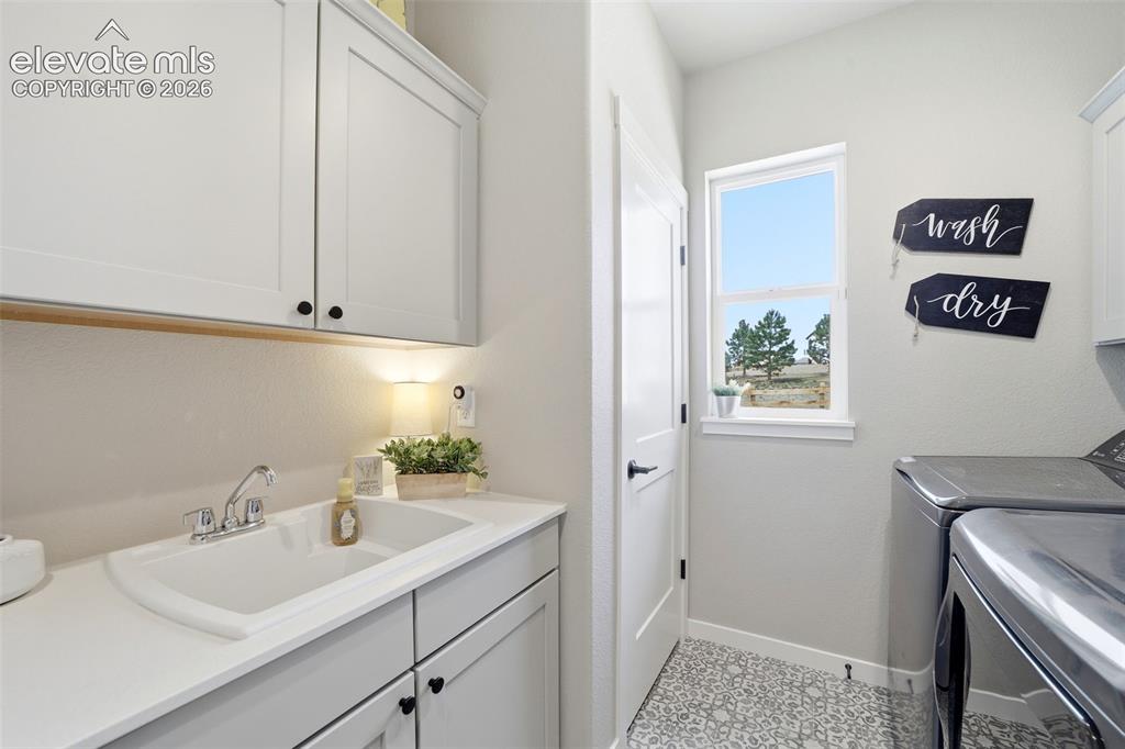 Image 25 of 49: Also added a utility sink & storage cabinets with a closet.
