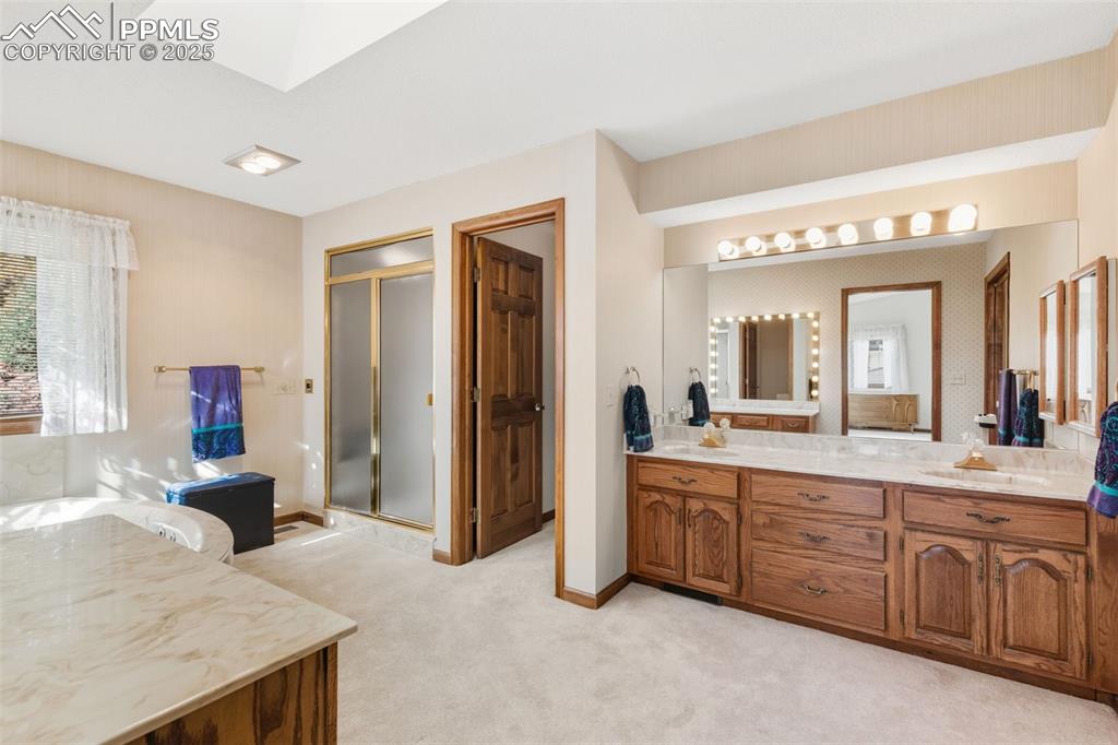 Image 31 of 48: Separate stand-alone shower, jetted tub, dual vanities, skylight