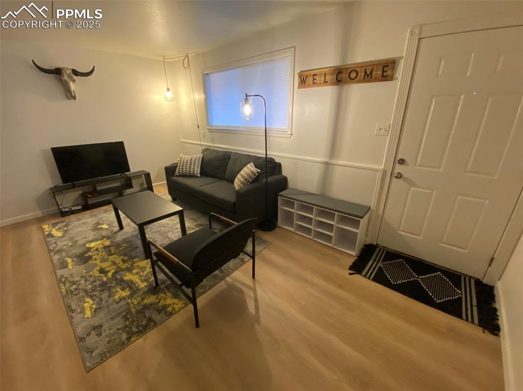 Image 10 of 28: 211-Unit B, Living area featuring light LVP flooring