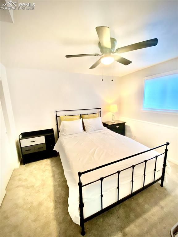 Image 11 of 28: 211-Unit B Bedroom 1 with light carpet and ceiling fan