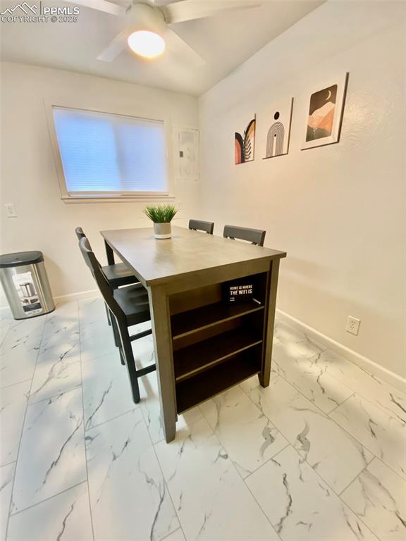 Image 14 of 28: 211-Unit B  Dining area with light marble finish tile flooring and a ceilin