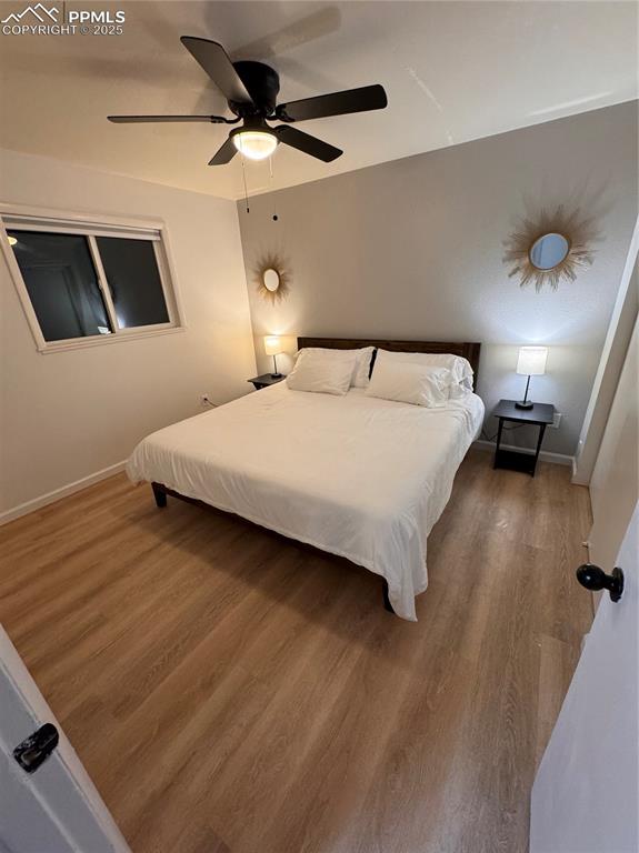 Image 18 of 28: 211-Unit C Bedroom 1 featuring LVP flooring and ceiling fan