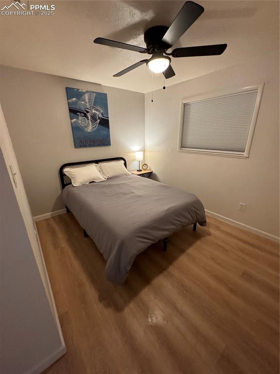 Image 19 of 28: 211-Unit C Bedroom 2 with LVP floor and a ceiling fan