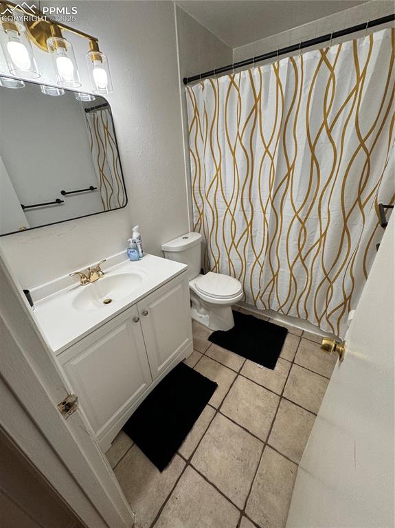 Image 20 of 28: 211-Unit C, Bathroom featuring vanity, light tile patterned flooring, a tub