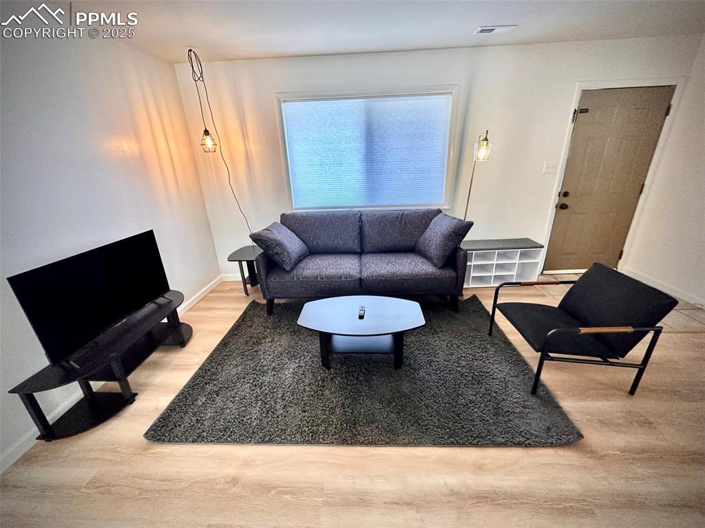 Image 23 of 28: 211-Unit D Living area with light wood-type flooring 