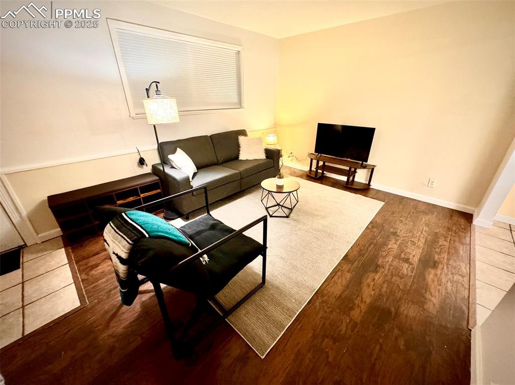 Image 4 of 28: 211-Unit A Living area with dark LVP flooring