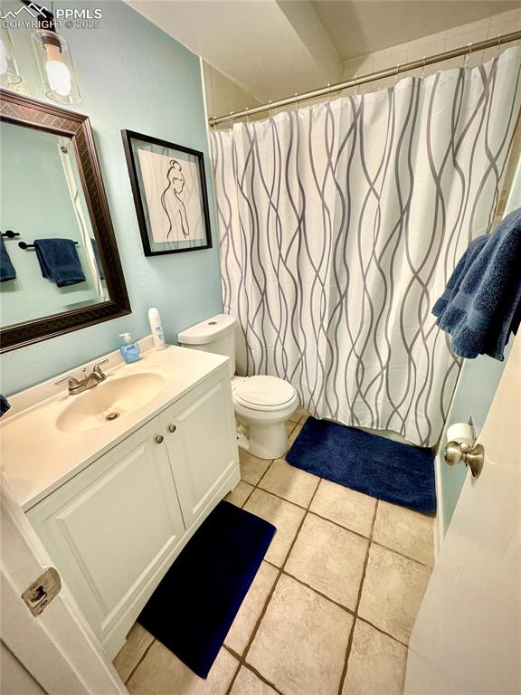 Image 8 of 28: 211-Unit A  Full bath with vanity and light tile patterned flooring, shower
