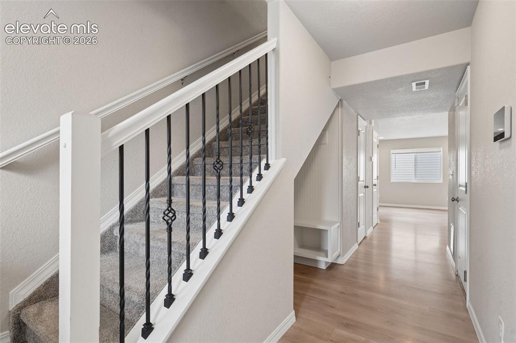 Image 8 of 36: You are welcomed inside the front door by luxury vinyl flooring and natural